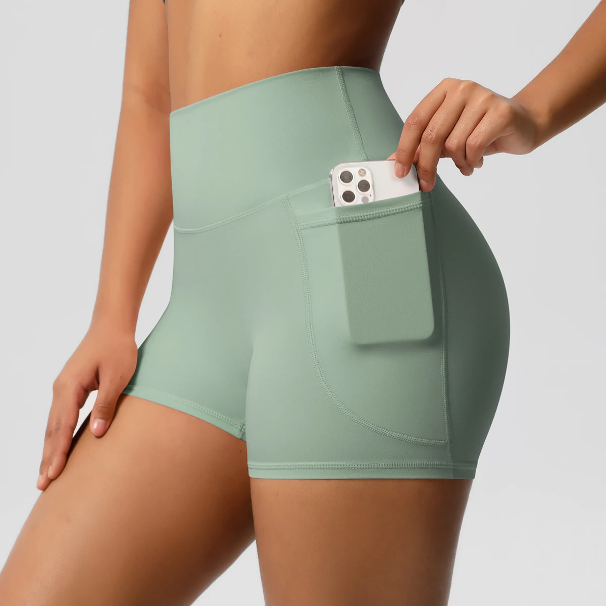 Pantalones cortos de nailon de Color sólido para mujer, pantalones cortos para levantar la barriga, ciclismo al aire libre, correr con bolsillos, pantalones cortos deportivos para gimnasio y Pilates