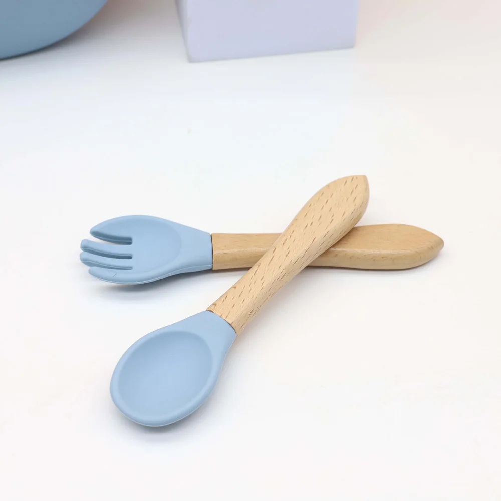 Juego de vajilla de silicona para bebé de 7 piezas, babero, plato, tazón con ventosa, vaso 2 en 1, taza para refrigerios, cuchara y tenedor de madera