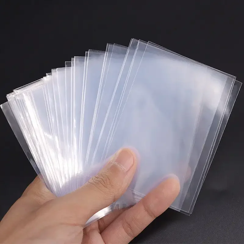 Fundas transparentes para tarjetas de 66x91mm, 100/300 Uds., protector de tarjetas transparente, bolsas de almacenamiento a prueba de arañazos y polvo para tarjetas de juego coleccionables