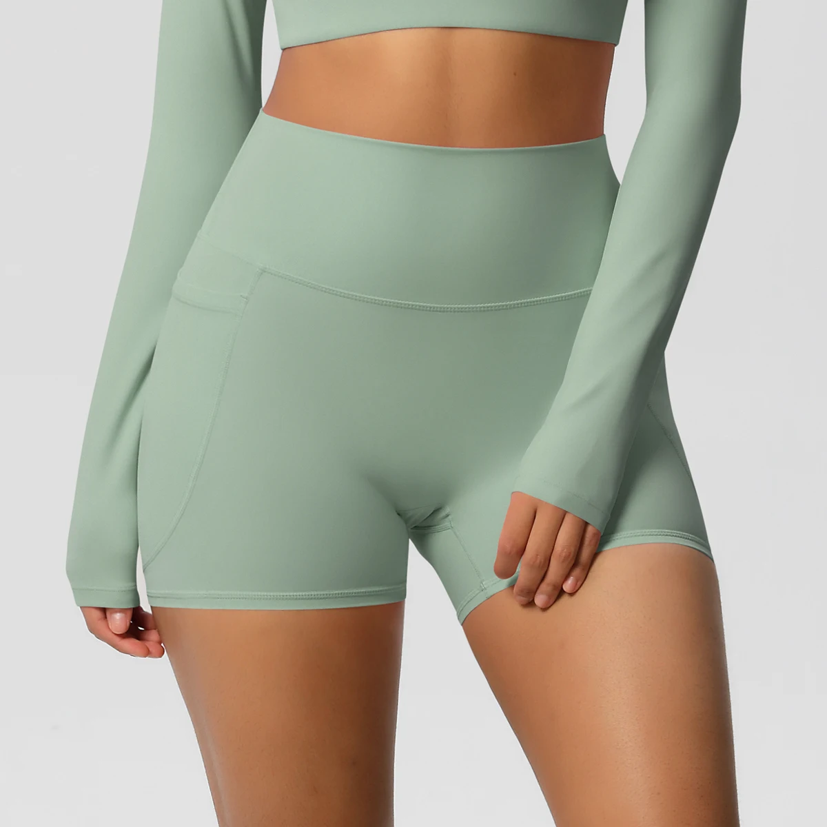 Pantalones cortos de nailon de Color sólido para mujer, pantalones cortos para levantar la barriga, ciclismo al aire libre, correr con bolsillos, pantalones cortos deportivos para gimnasio y Pilates