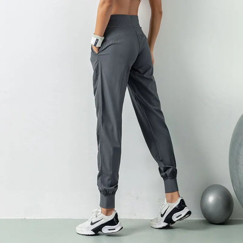 Pantalones deportivos de secado rápido para mujer con dos bolsillos laterales