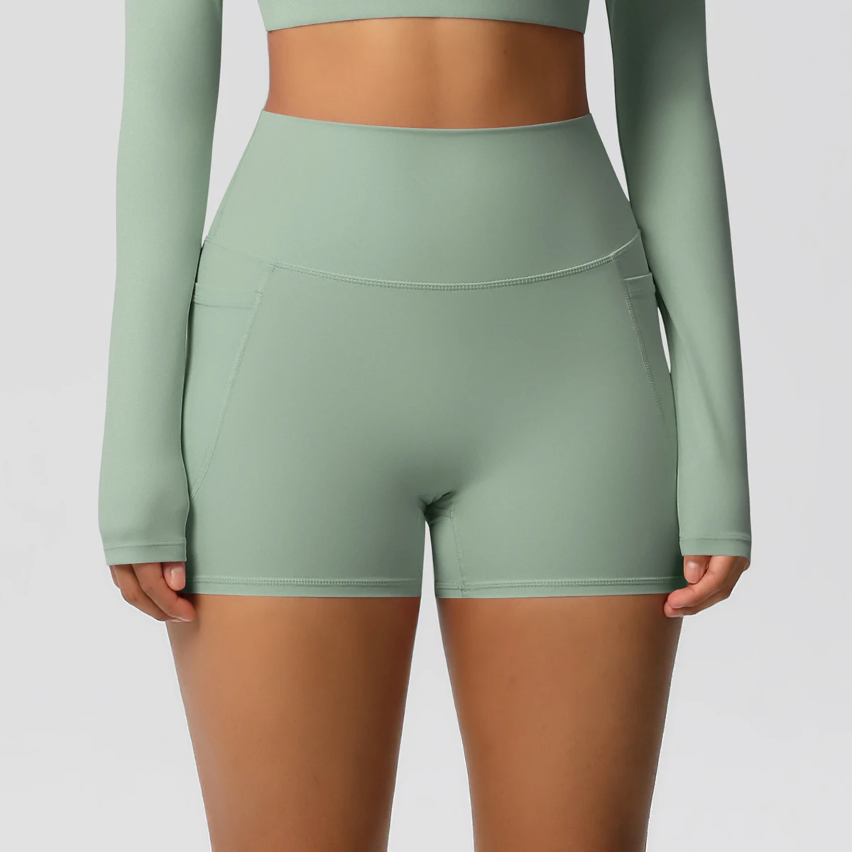 Pantalones cortos de nailon de Color sólido para mujer, pantalones cortos para levantar la barriga, ciclismo al aire libre, correr con bolsillos, pantalones cortos deportivos para gimnasio y Pilates