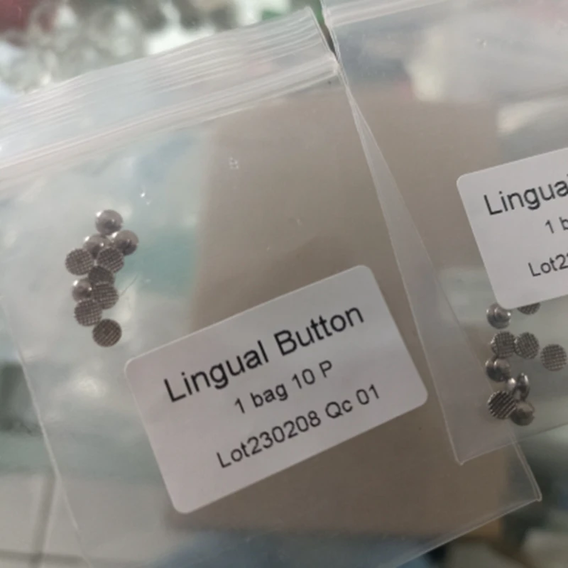 100 Uds. Botón Lingual Dental ortodoncia adhesivo Metal malla redonda lengua hebilla lateral Base redonda